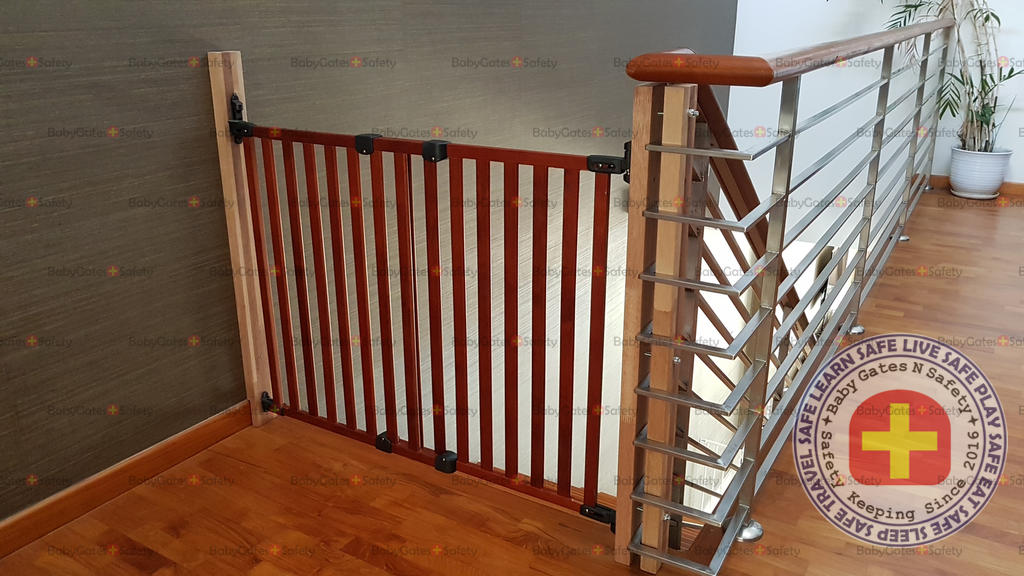 Kidco Wooden Safeway Wall Mounted Gate installed at top of stairs